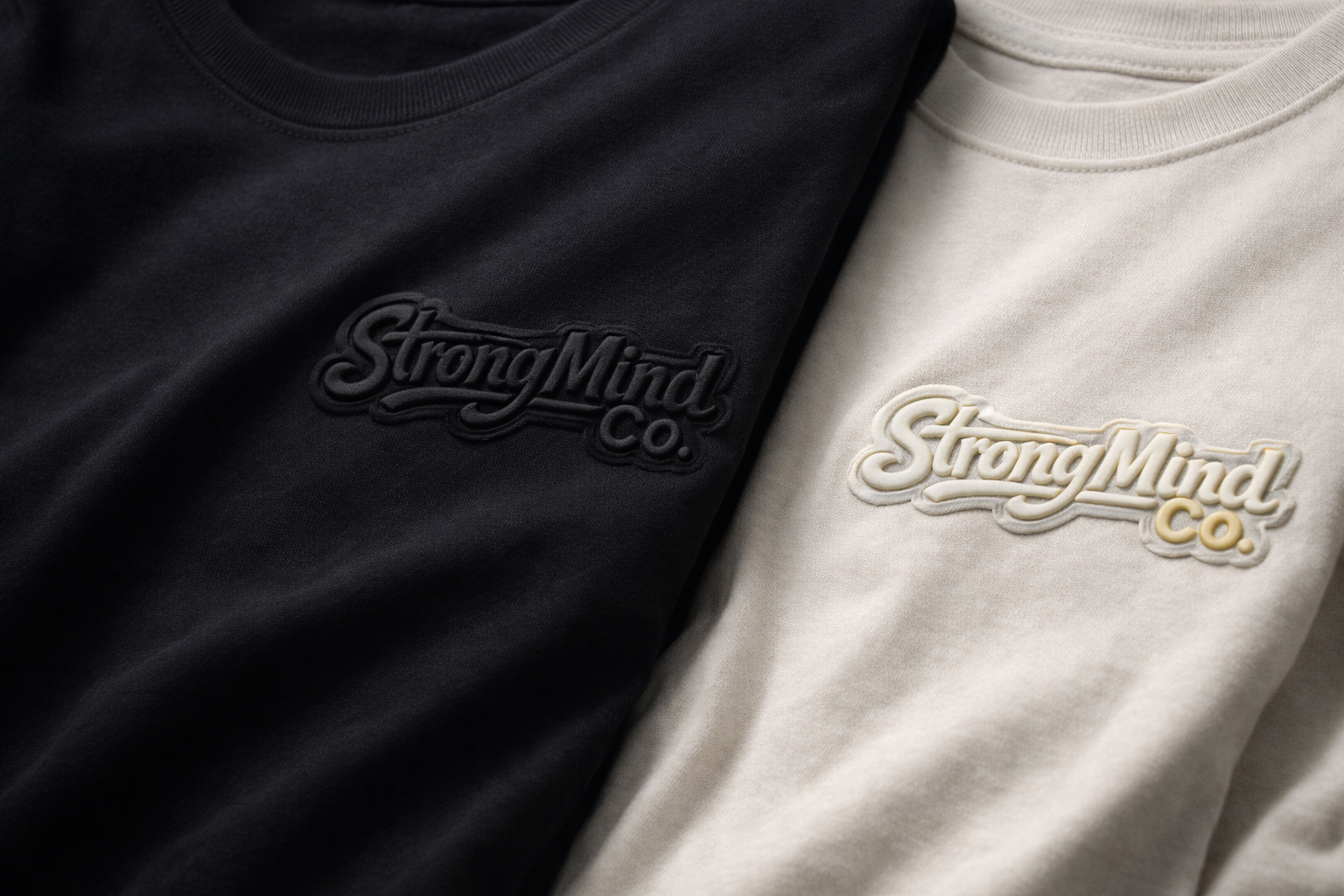 Black and white t-shirts with 'StrongMind Co.' logo on a plain background